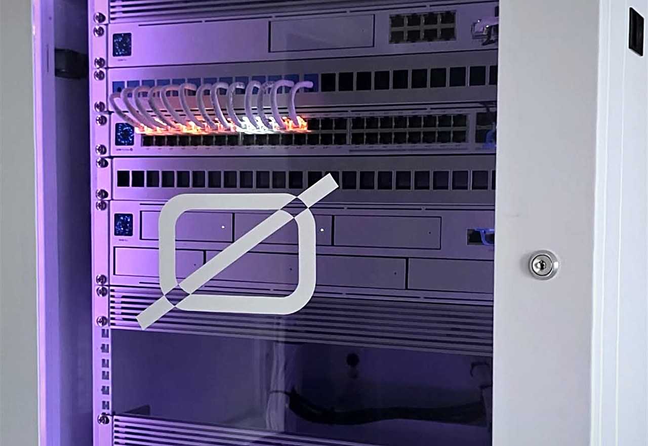 OMEGA Security UniFi network rack with glowing purple lighting